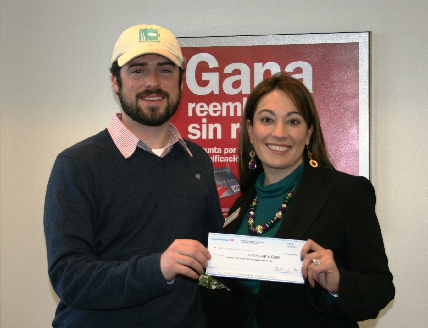 Save the Sound's Kierran Broatch (left) accepts a grant check from Bank of America's Natalia Salazar-Treloar