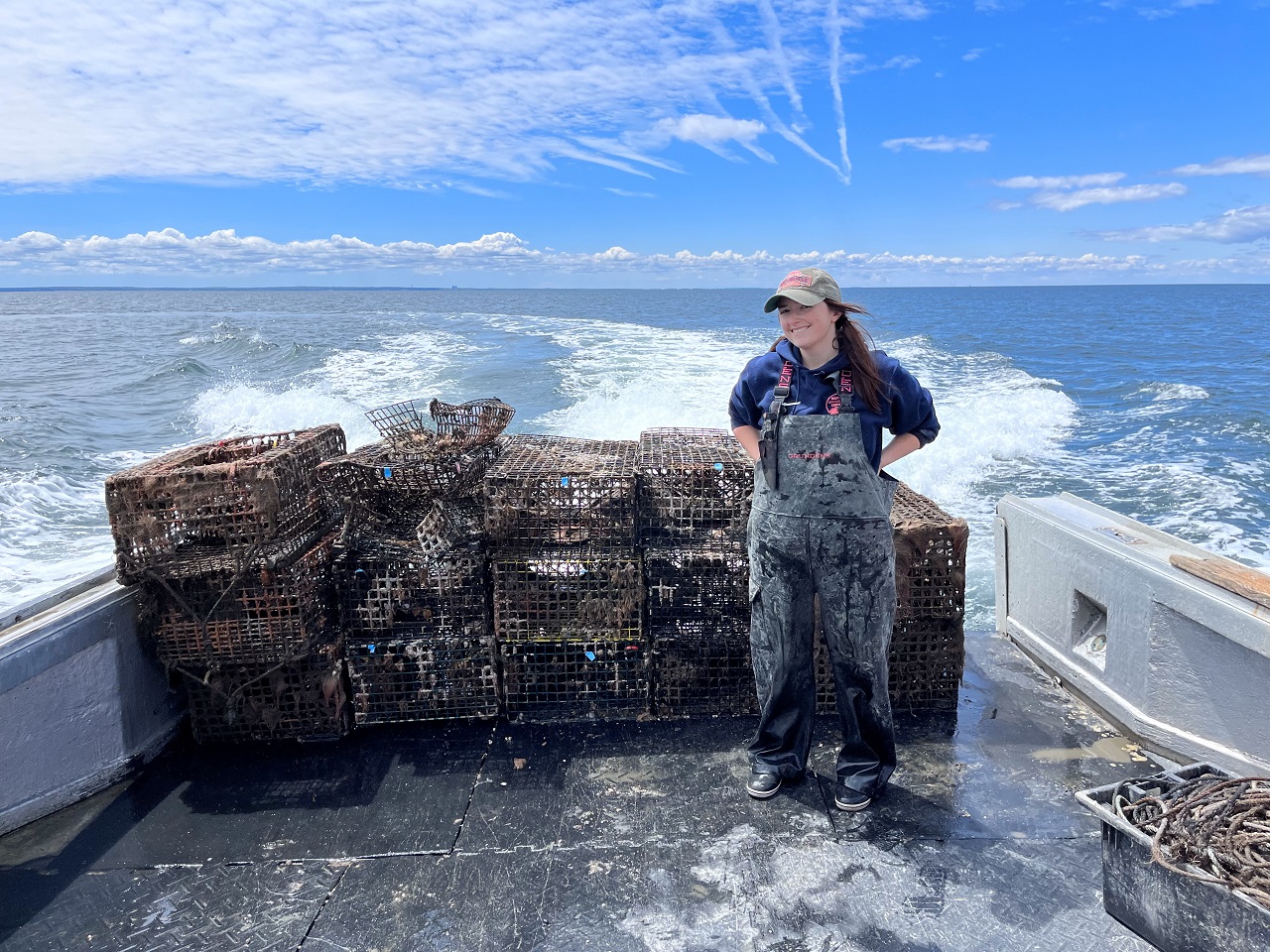 Emma on boat with lobster traps
